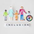 family with disables person cutout paper inclusion concept